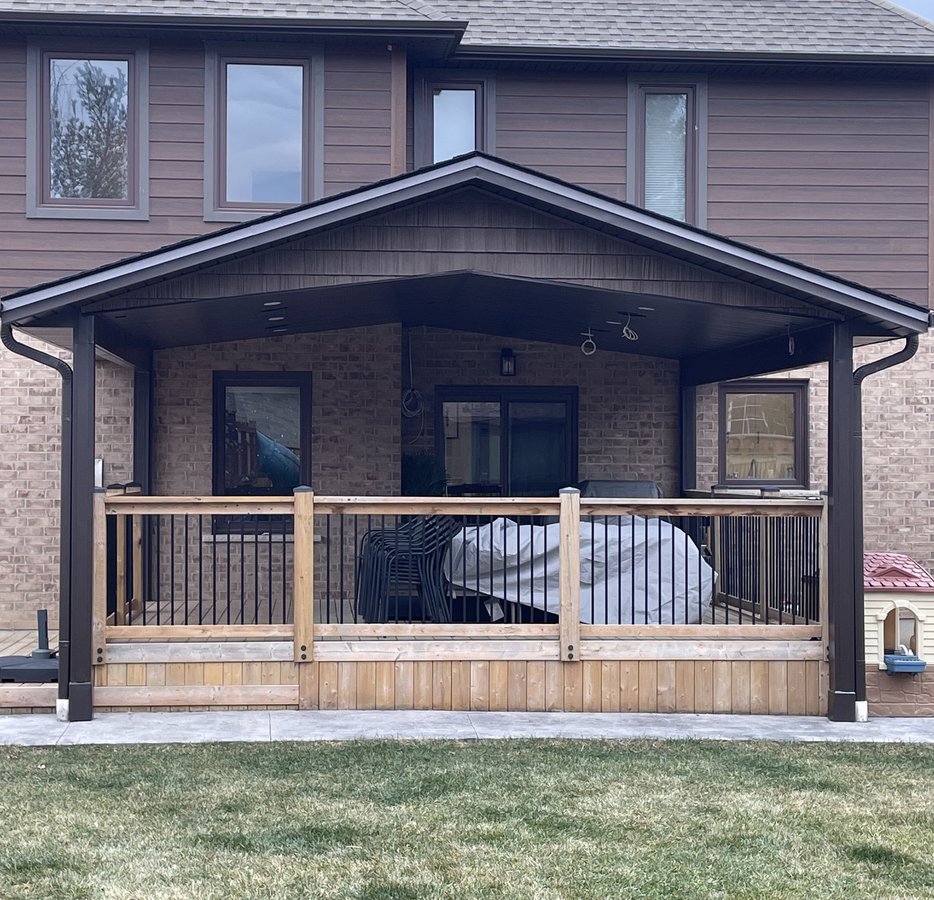 gable roofed covered porch with cedar railing built by Baird Construction in Woodstock ON